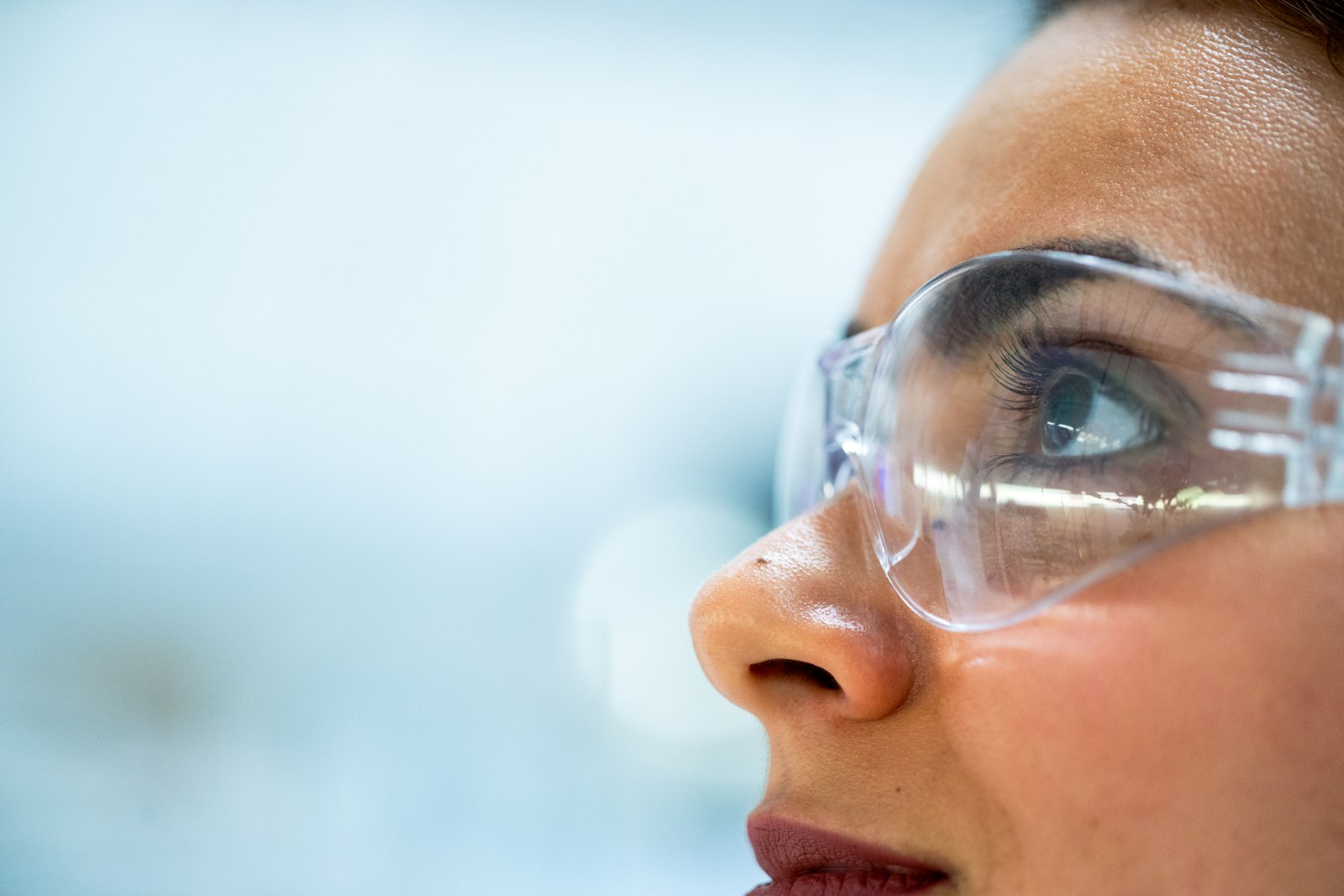 Maker in safety goggles inspecting work
